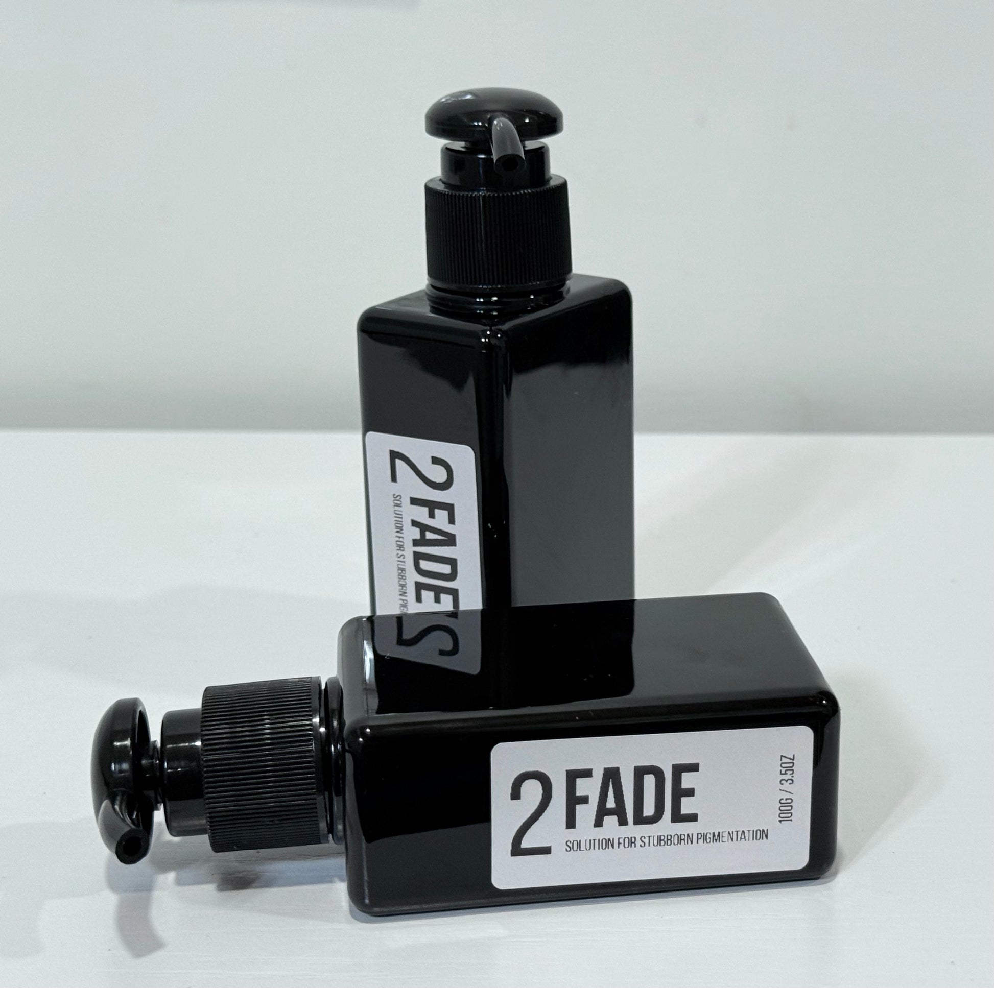 Two black cosmetic bottles both from the brand Fafi’s best with white labels that says 2 fade solution for stubborn pigmentation 